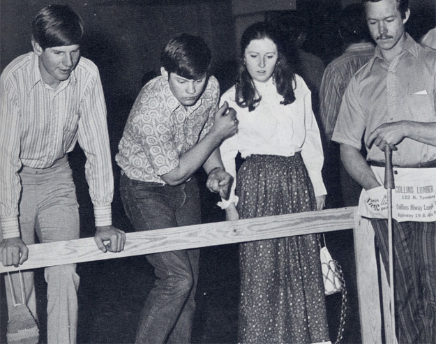 Spring Carnival 1972: "Industrial Arts lures crowd with Lady Luck at the penny pitch booth."