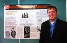 Josh Belcher of Ada stands at the national Beta Beta Beta convention in San Juan, Puerto Rico, with a poster detailing the nationally recognized research