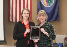 Stacey Bolin, left, and Charlee Lanis hold the Exceptional Program Award for Best Conference in the Great Plains Region of the Association for Continuing Higher Education.