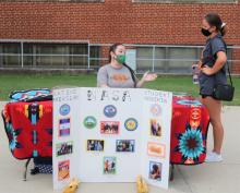 A student visits the Native American Student Association booth at the ECU Block Party that traditionally kicks off the fall semester. A new comparative study has recognized ECU as one of the most affordable institutions of higher learning in the country in terms of low student loan debt.