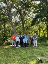 East Central University students and CNES personnel are pictured with the CNES Director Phillip Cravatt (left) and Dr. Moring (right) at the site near the Blue River.