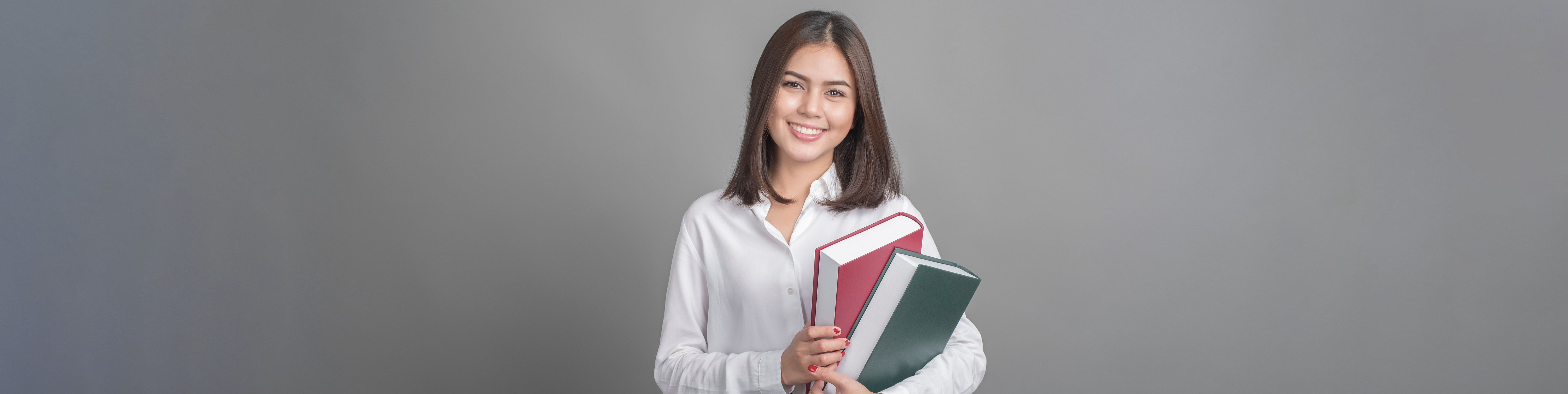 Woman smiling holding books