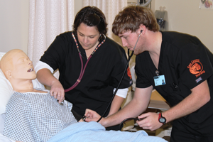 nursing students with practice dummy