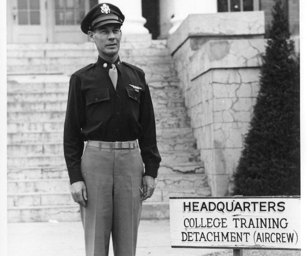 Pictured of a young cadet in front of the sign for the air training crew.