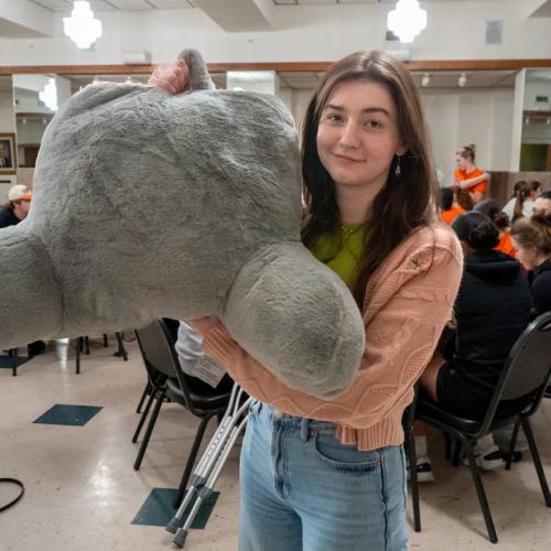 A student poses with her new pillow chair.