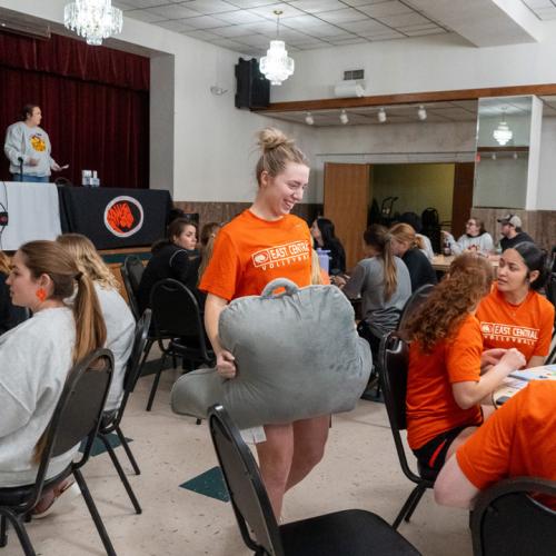 Students chat about what prizes they hope to win between rounds of bingo.