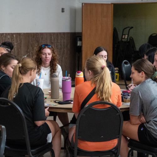 Students chat about what prizes they hope to win between rounds of bingo.