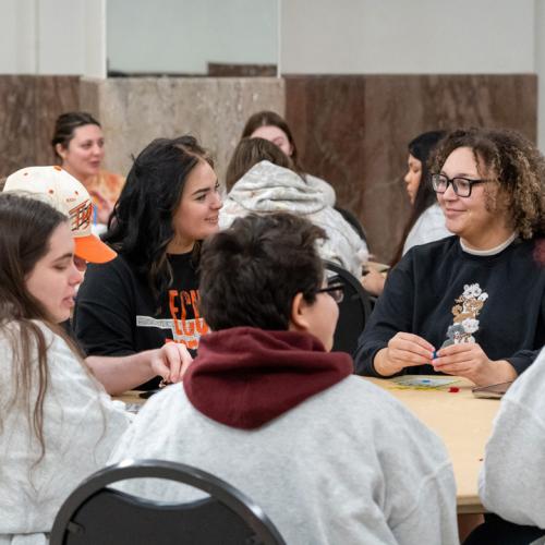 Students chat about what prizes they hope to win between rounds of bingo.