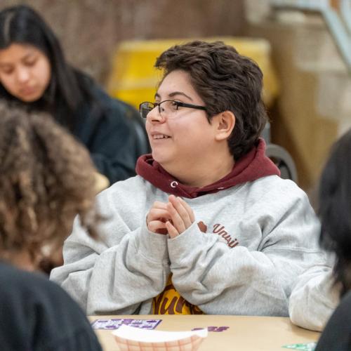 A student watches the caller waiting for her lucky number to be called.