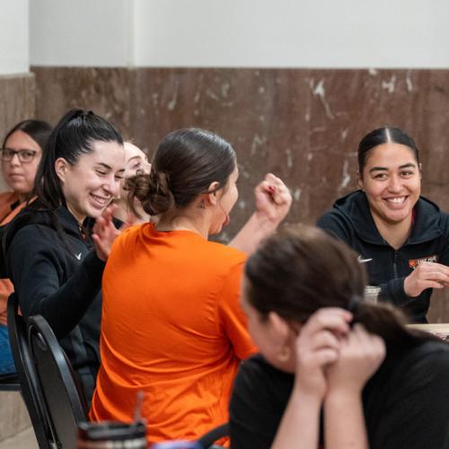 A student and her friends celebrate winning a round of bingo.