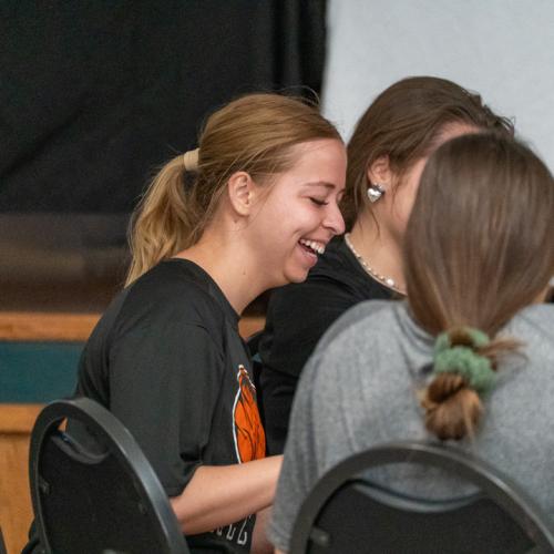 A girl laughs with joy after winning a round of bingo.