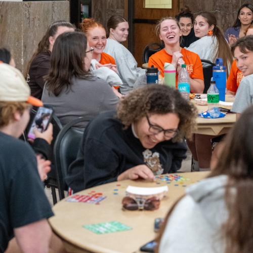 A girl wins a 40 inch TV in the final round of Lucky Tiger Bingo with a blackout and other students cheer for her.